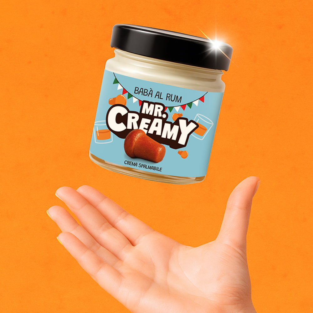 Vasetto da 200g di crema spalmabile Mr Creamy gusto Babà al Rum mentre viene lanciato in aria